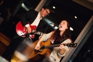 Randall and Mélodie Spear, playing guitar and singing together